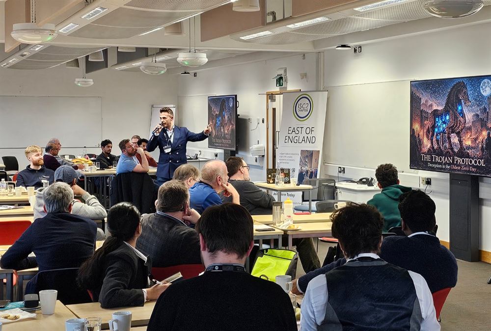 A speaker presenting The Trojan Protocol to a full room